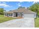 Charming single-story home with a well-manicured lawn, two car garage and lush flowerbeds enhancing its curb appeal at 2251 Evenglow Ave, Spring Hill, FL 34609