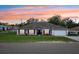 Charming single-story home with a well-manicured lawn, and lush flowerbeds enhancing its curb appeal at 2251 Evenglow Ave, Spring Hill, FL 34609