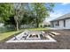 Inviting backyard fire pit area with seating, creating a cozy and picturesque setting for outdoor enjoyment at 2251 Evenglow Ave, Spring Hill, FL 34609
