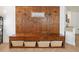Mud room featuring built-in bench and storage baskets below and coat hooks and 'Welcome' sign above at 2251 Evenglow Ave, Spring Hill, FL 34609