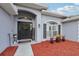 Inviting front entrance featuring a decorative wreath, accent flowers, and a charming 'Welcome' sign at 2251 Evenglow Ave, Spring Hill, FL 34609