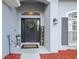 Inviting front entrance featuring a decorative wreath, accent flowers, and a charming 'Welcome' sign at 2251 Evenglow Ave, Spring Hill, FL 34609