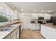 Well-lit kitchen features a double sink, ample counter space, modern appliances, and a door to the outside at 2251 Evenglow Ave, Spring Hill, FL 34609