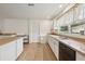 Bright kitchen features ample counter space, a double sink, and a door to the outside at 2251 Evenglow Ave, Spring Hill, FL 34609