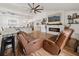 Spacious living room with open floor plan, fireplace feature, and comfortable leather seating, perfect for relaxation at 2251 Evenglow Ave, Spring Hill, FL 34609