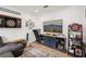 Living room with a television, modern furnishings, and a dartboard hanging on the wall at 2251 Evenglow Ave, Spring Hill, FL 34609