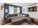 Living room featuring a sectional sofa, accent pillows, and natural light at 2251 Evenglow Ave, Spring Hill, FL 34609