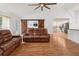 Spacious living area with modern decor, barn door accent, and comfortable seating, offering a welcoming atmosphere at 2251 Evenglow Ave, Spring Hill, FL 34609