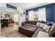 Open living room featuring a plush sofa, natural light, and view into the other rooms at 2251 Evenglow Ave, Spring Hill, FL 34609