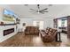 Spacious living room with comfortable leather seating, a modern fireplace, and stylish decor, perfect for relaxation at 2251 Evenglow Ave, Spring Hill, FL 34609