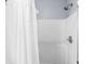 Clean shower with white tile, shower curtain, and chrome fixtures at 2251 Evenglow Ave, Spring Hill, FL 34609
