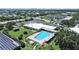 Aerial view of a commercial building and outdoor pool surrounded by green space at 2261 Swedish Dr # 37, Clearwater, FL 33763