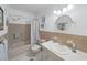 Bathroom with vanity, tub, shower, and tiled walls at 2261 Swedish Dr # 37, Clearwater, FL 33763