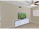 Bedroom showcases a dresser with TV, neutral walls, and bright window at 2261 Swedish Dr # 37, Clearwater, FL 33763