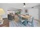 Charming dining room with a light blue table set and views into the kitchen and living room at 2261 Swedish Dr # 37, Clearwater, FL 33763