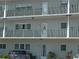 Exterior view of building featuring multiple units and balconies with white railings and visible unit number 37 at 2261 Swedish Dr # 37, Clearwater, FL 33763