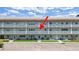 Apartment building exterior view showcasing the front doors, patios, and landscaping of multiple units at 2261 Swedish Dr # 37, Clearwater, FL 33763