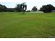 Expansive view of the golf course with mature trees and automatic sprinklers for irrigation and lush greenery at 2261 Swedish Dr # 37, Clearwater, FL 33763