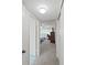 Hallway leading into bedroom, features a bed, desk, and closet at 2261 Swedish Dr # 37, Clearwater, FL 33763