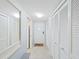 Hallway view featuring tiled floors, storage closets, and a front door with a decorative welcome mat at 2261 Swedish Dr # 37, Clearwater, FL 33763