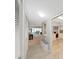 Open hallway view with decorative mirror, storage, and a view leading into the living and dining area at 2261 Swedish Dr # 37, Clearwater, FL 33763