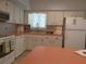 Functional kitchen with plentiful cabinetry, countertop space, modern appliances and a view of the dining area at 2261 Swedish Dr # 37, Clearwater, FL 33763