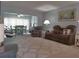 Open-concept living room with plush seating, carpet, and a view to the dining area at 2261 Swedish Dr # 37, Clearwater, FL 33763