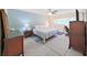 Bedroom boasts a bed, blue accent wall, and a desk near the window at 2261 Swedish Dr # 37, Clearwater, FL 33763
