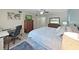 Spacious bedroom with a bed, desk, dresser, and ample natural light at 2261 Swedish Dr # 37, Clearwater, FL 33763