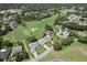 Aerial view of the golf course community, showcasing the lush greenery and well-manicured grounds, with homes surrounding the greens at 2275 Terrace View Ln, Spring Hill, FL 34606
