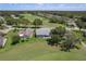 Aerial view of a house with a golf course community surrounded by mature trees and landscaping at 2275 Terrace View Ln, Spring Hill, FL 34606