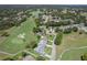 Aerial view of homes in a golf community with a lake in the distance at 2275 Terrace View Ln, Spring Hill, FL 34606