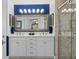 Bright bathroom with a double sink vanity, large mirror and walk-in shower with stone tile at 2275 Terrace View Ln, Spring Hill, FL 34606