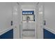 En suite bath showcasing dual vanities and a blue, white, and silver décor at 2275 Terrace View Ln, Spring Hill, FL 34606