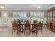 Sunlit dining room with plantation shutters and stylish furniture for elegant dining at 2275 Terrace View Ln, Spring Hill, FL 34606