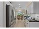 Galley kitchen featuring stainless steel appliances and a cozy breakfast nook at 2275 Terrace View Ln, Spring Hill, FL 34606