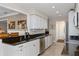 Bright kitchen featuring granite countertops, stainless steel appliances, and tiled flooring at 2275 Terrace View Ln, Spring Hill, FL 34606