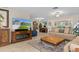 Bright living room with neutral tones, featuring a fireplace and large television at 2275 Terrace View Ln, Spring Hill, FL 34606