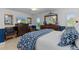 The main bedroom with a bed, chairs, and two dressers at 2275 Terrace View Ln, Spring Hill, FL 34606