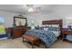 Beautiful bedroom with a decorative bed, a dresser, and a ceiling fan at 2275 Terrace View Ln, Spring Hill, FL 34606