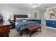 The main bedroom with a bed, lamps, and white and blue colored décor at 2275 Terrace View Ln, Spring Hill, FL 34606
