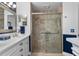 Stylish bathroom with a glass shower door and walls tiled with light stone at 2275 Terrace View Ln, Spring Hill, FL 34606