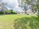 The backyard features plenty of space and lush greenery at 2414 San Luis Rd, Holiday, FL 34691