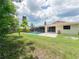 Enjoy a screened pool and patio in this home's spacious backyard at 2414 San Luis Rd, Holiday, FL 34691