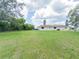 Expansive backyard featuring lush green space surrounds this home at 2414 San Luis Rd, Holiday, FL 34691