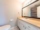 Half bath with single sink vanity and decorative accent wall at 2414 San Luis Rd, Holiday, FL 34691