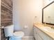 Cozy bathroom featuring wood accent wall, mosaic tile floor and modern sink vanity at 2414 San Luis Rd, Holiday, FL 34691