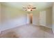 Bedroom featuring carpet flooring, a ceiling fan, and access to the closet at 2414 San Luis Rd, Holiday, FL 34691