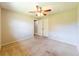Bedroom with carpet flooring, a ceiling fan, and access to the closet at 2414 San Luis Rd, Holiday, FL 34691