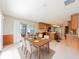 Open-concept dining room connecting to the kitchen and leading to the outdoor patio at 2414 San Luis Rd, Holiday, FL 34691